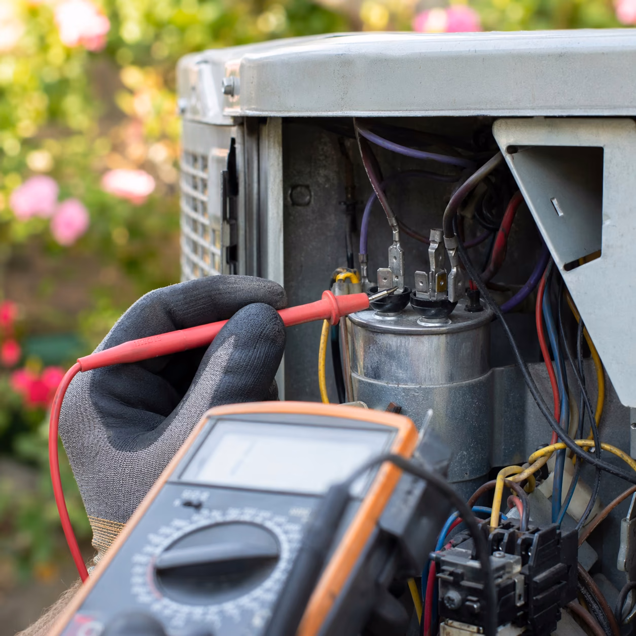 AAERO HVAC technician diagnosing a home air conditioning system with a multimeter before quoting an upfront repair estimate
